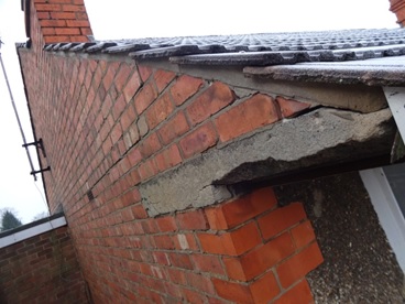 Gable lintel cracked and brickwork above dropping waiting for roof to drop.